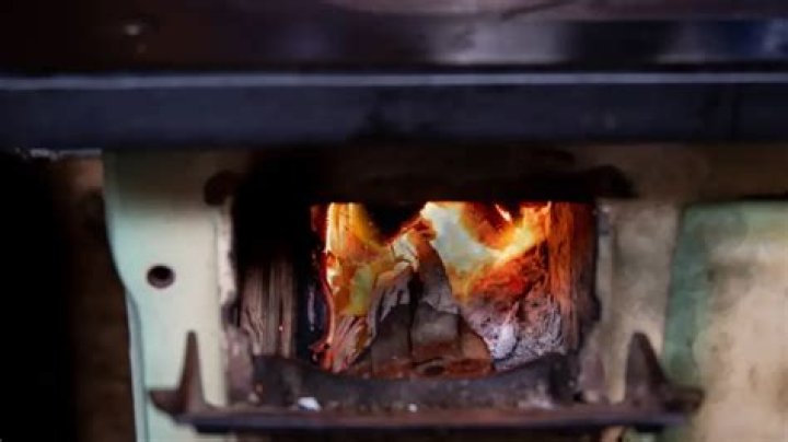 Why does my wood stove puff out smoke?